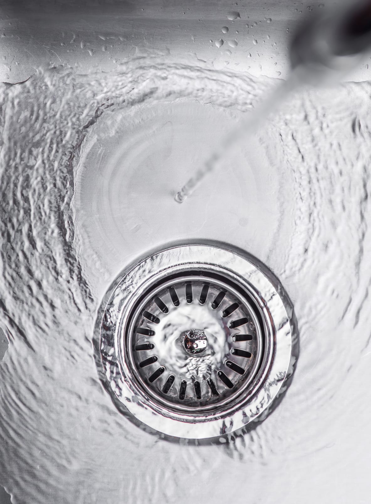 Water flowing down the hole in a kitchen sink
